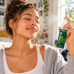 Teenage girl refreshing her face with Farrell Naturals Hydrating Mist Toner in a bright bedroom.