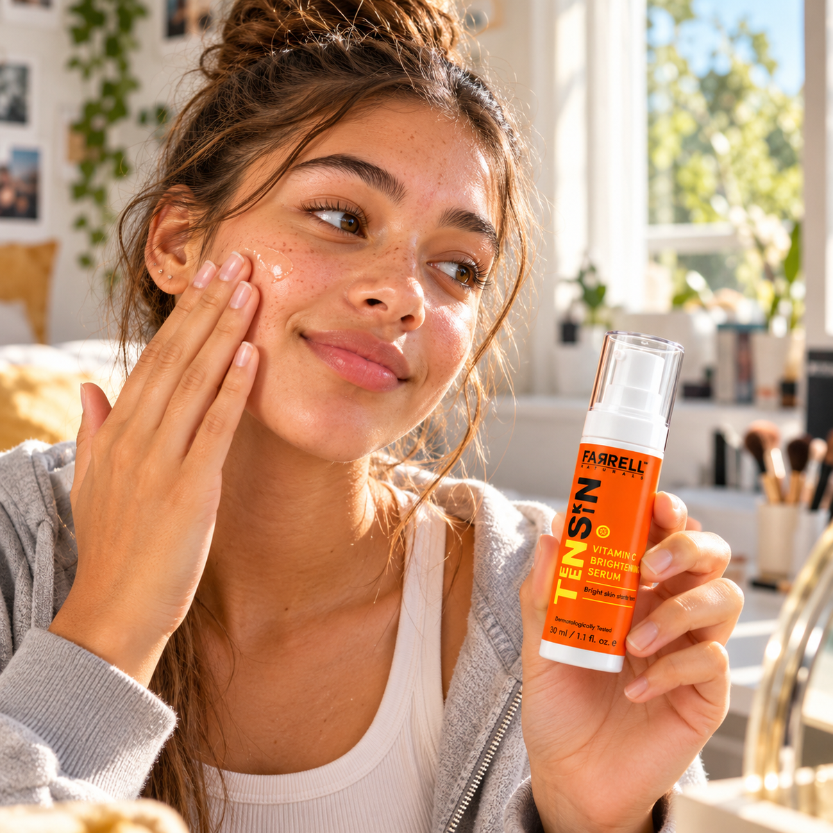Teenage girl applying serum to her cheek while holding Farrell Naturals Vitamin C Brightening Serum.