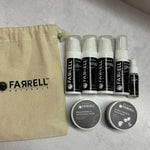 Collection of Farrell Naturals skincare products including bottles and jars on a light gray background.
