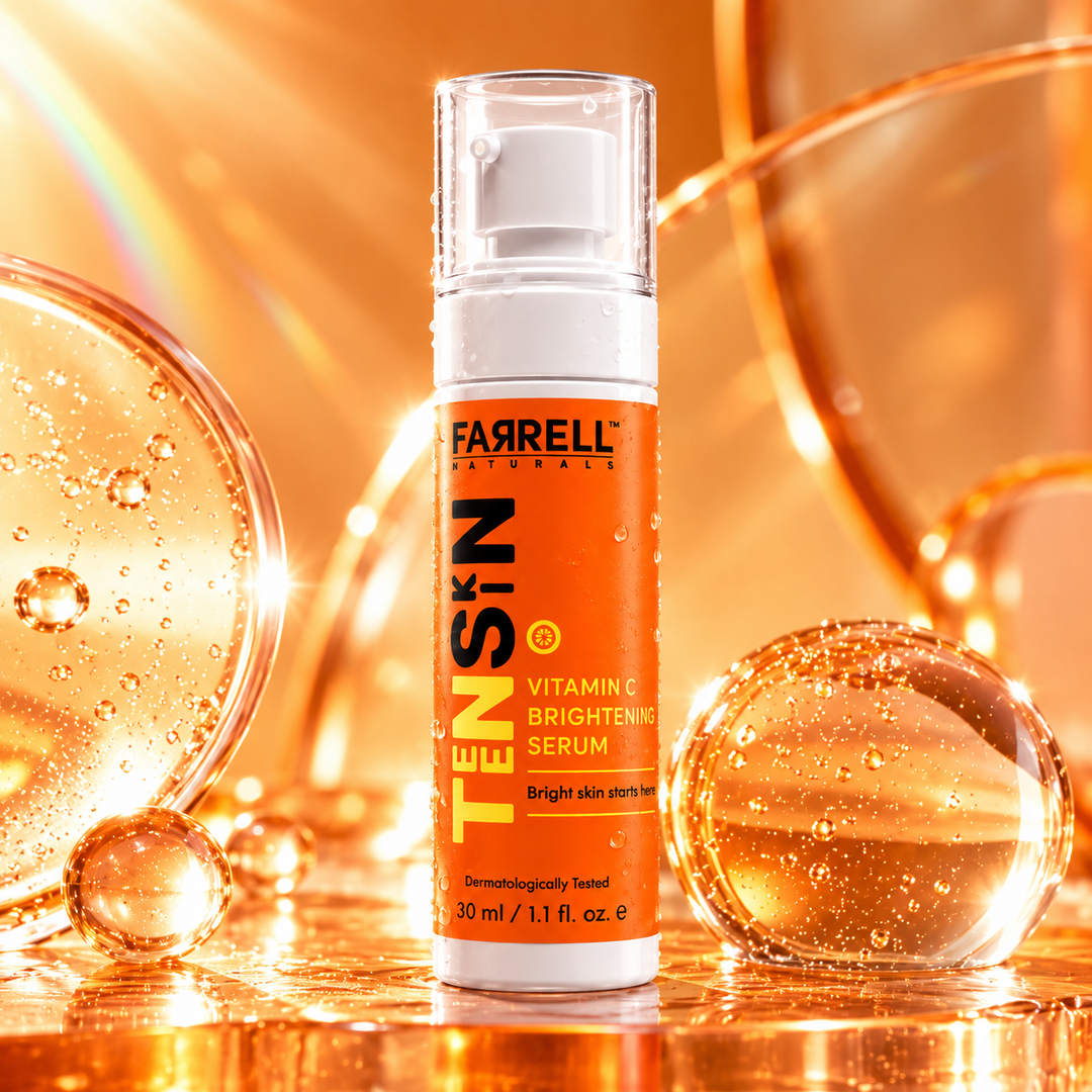 Farrell Naturals Vitamin C Brightening Serum bottle surrounded by golden orange serum droplets and warm reflections.